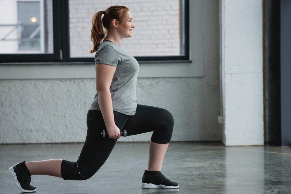 A woman wearing black compression shapewear leggings. Find out the benefits to wearing compression leggings and how they can help you!