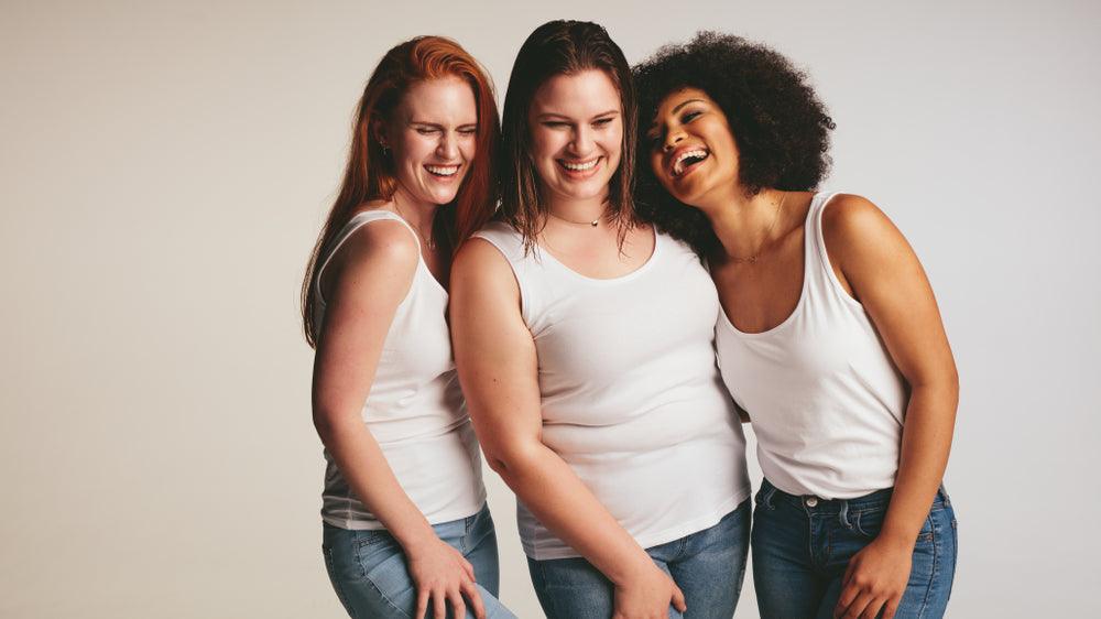 A tight-knit group of women expressing their body positive joy. Have you wondered where the term cellulite came from? Read our article to learn more.